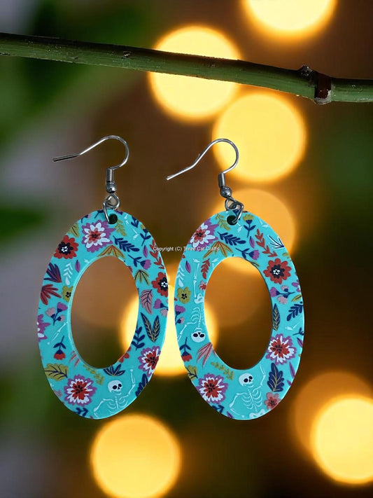 Teal Acrylic Drop Earrings with Floral Pattern and White Skeletons